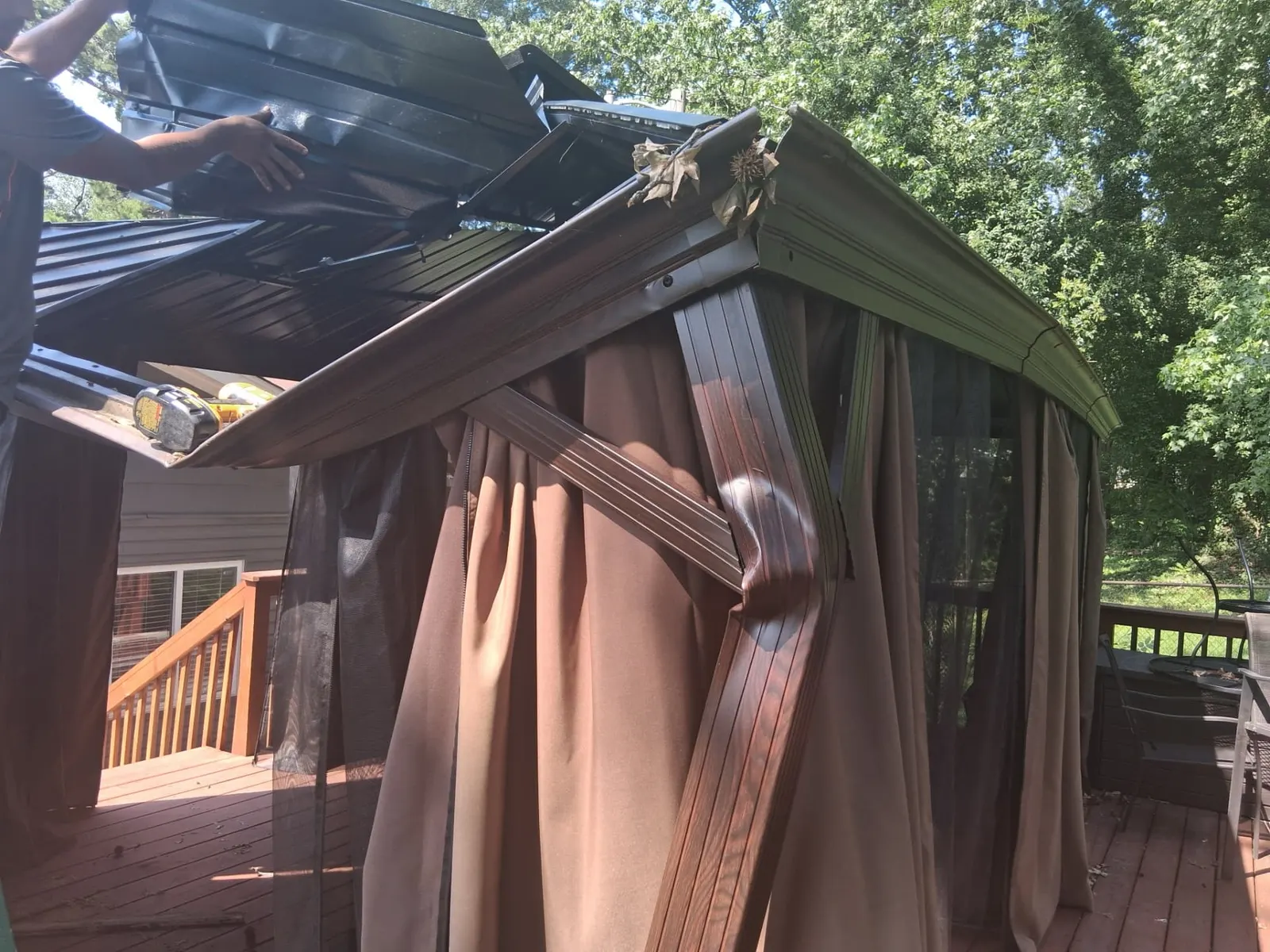 Backyard gazebo structure being taken apart panel by panel in Charlotte, NC